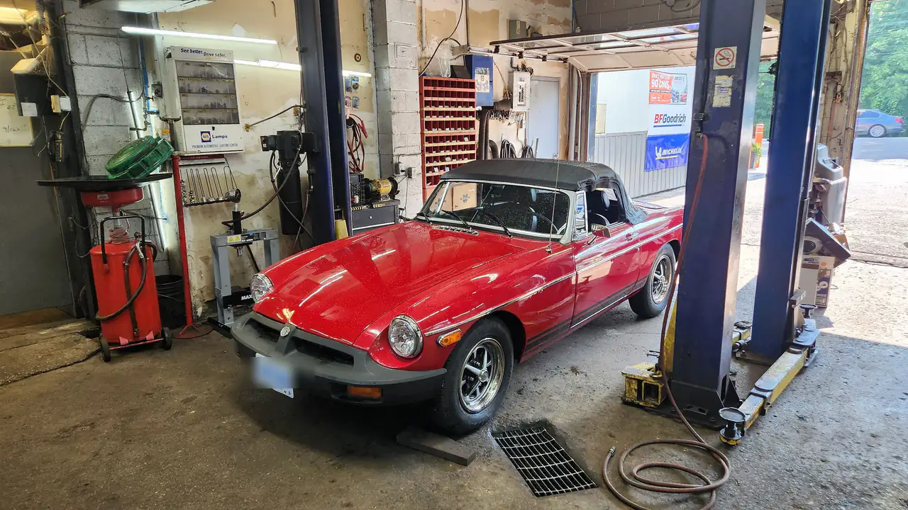 Inside the Mountain Automotive workshop in Grimsby — a classic convertible on the two-post hoist